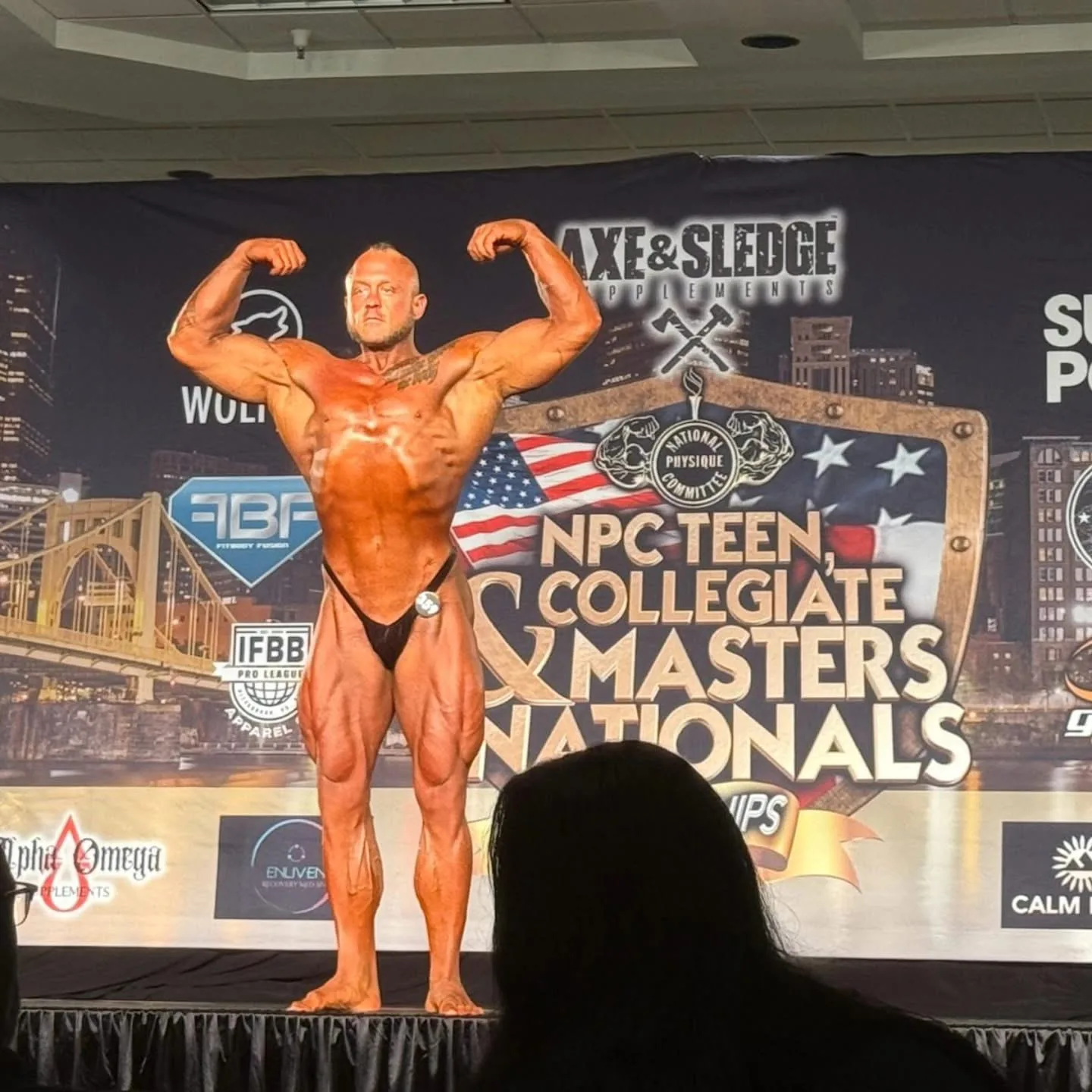 Derek Cundiff performing a front double-biceps pose at NPC Masters Nationals